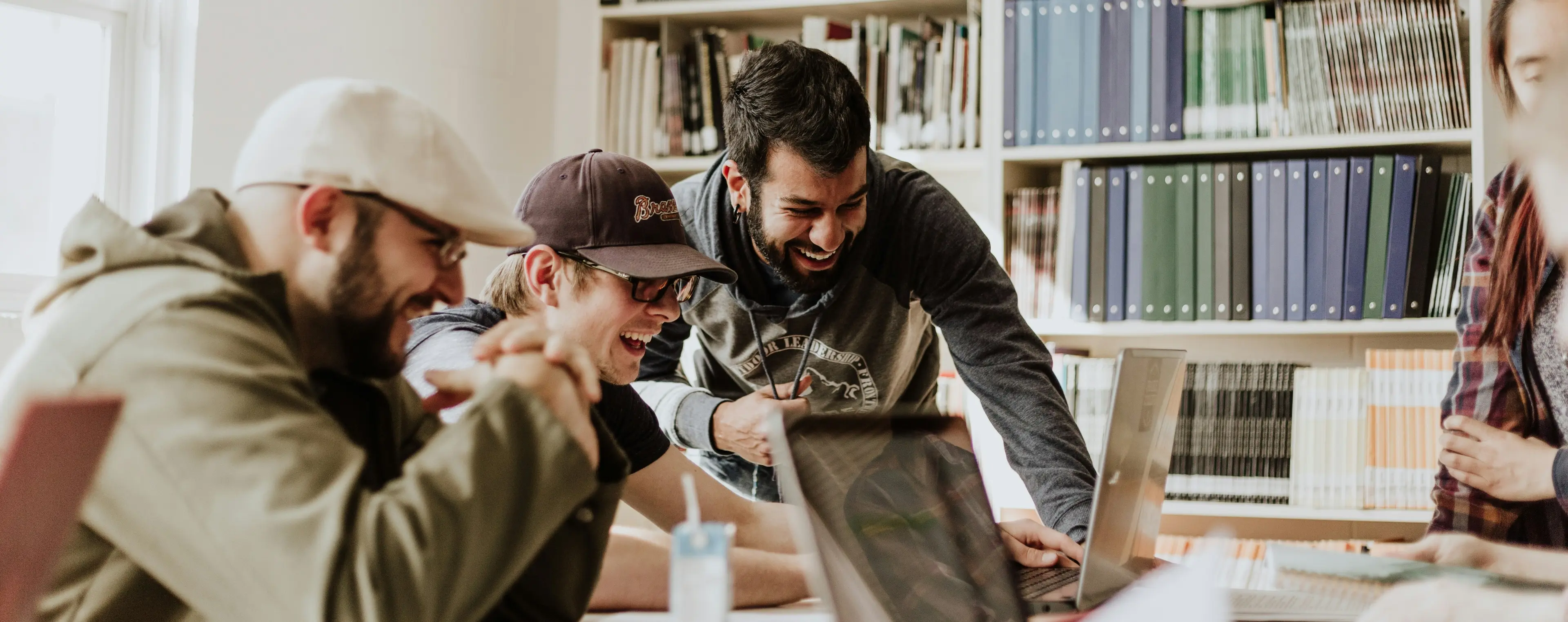 Team gathered around a computer working on tech marekting rebrand activities